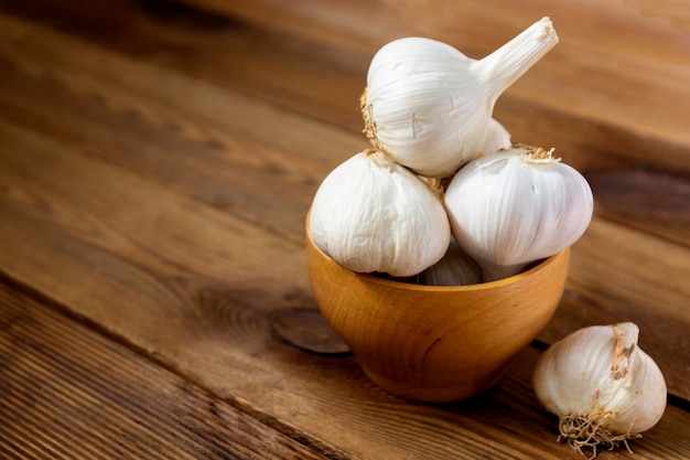 Garlic in a wooden bowl in the kitchen