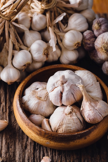garlic in wooden bowl on wooden 