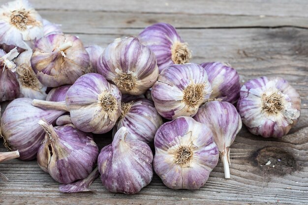 Garlic on wooden vintage background Seedlings for planting garlic