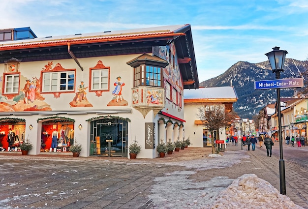 Garmisch-Partenkirchen, Germany - January 6, 2015:  Square in Bavarian style decorated for Christmas in Garmisch Partenkirchen old town, Germany. People on the background