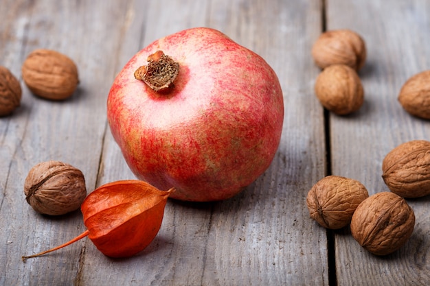 Garnet with walnuts  on a wooden background