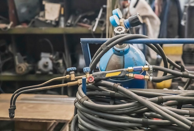 Gas cylinder, hose and blowtorch at the factory