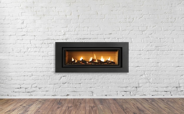 Photo gas fireplace on white brick wall in bright empty living room interior of house