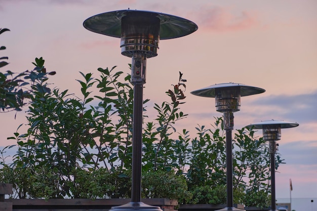 Photo gas heaters stand on the veranda of the cafe, at sunset