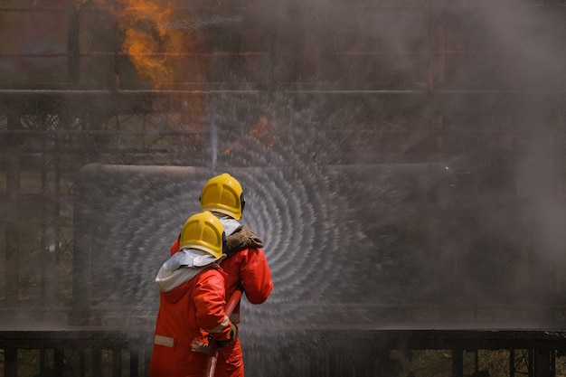 Gas leak from pipe and valv.flame from gas leak.fire fighting with extingguishers and fire hose.fighters in action at gas Fire