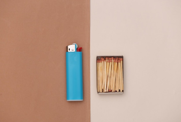 Photo gas lighter and matches on beige brown background