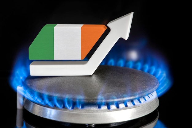 Gas price Rise in gas prices in Ireland A burner with a flame and an arrow up painted in the colors of the Ireland flag The concept of rising gas or energy prices