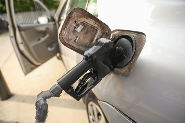 gas station and gas pump nozzle depict convenience energy consumption transportation fossil fuels