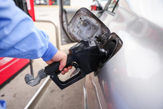 Photo gas station price surge symbol of economic strain rising costs and financial pressure due to infl