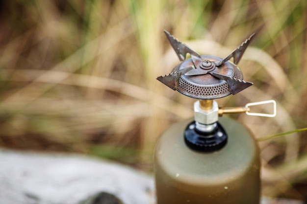 Gas stove on wood on forest background Lunch during the journey to the wild Camping lifestyle