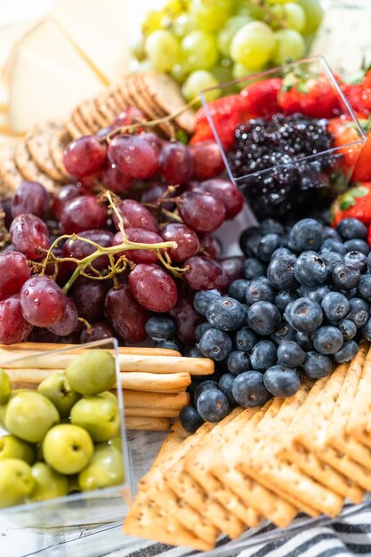 Gastronomische feestkaasschotel met fruit, kaas en crackers.