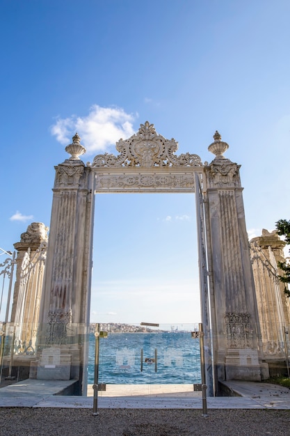 Gates near the Dolmabahce Palace leading to the Bosphorus Strait with glass fence in front and city of it in Istanbul, Turkey