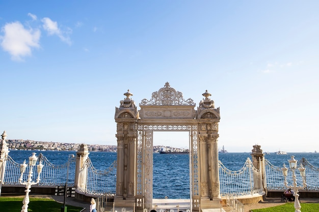 Gates near the Dolmabahce Palace leading to the Bosphorus Strait with glass fence in front and city of it in Istanbul, Turkey