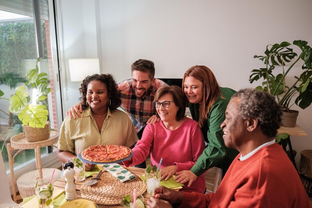 Gathering of friends around a table eating and enjoying together Concept diversity friendship