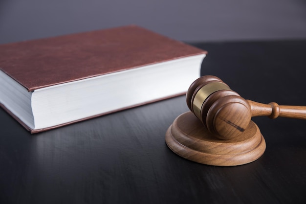 Gavel and book on wooden table backgroundxAxAxAxA