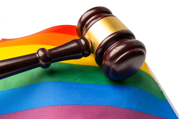 Gavel for judge lawyer on rainbow flag, symbol of LGBT pride month.