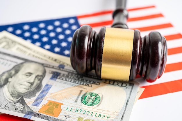 Gavel for judge lawyer and US dollar banknotes on USA America flag finance concept