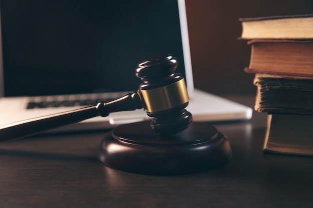 Gavel , laptop, books and scales on brown background ,judiciary and legislature courtroom legal concept. top view flatlay lawyer background