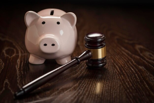 Photo gavel and piggy bank on wooden table