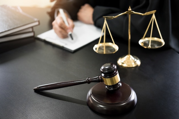 Photo gavel and soundblock of justice law and lawyer working on wooden desk background.