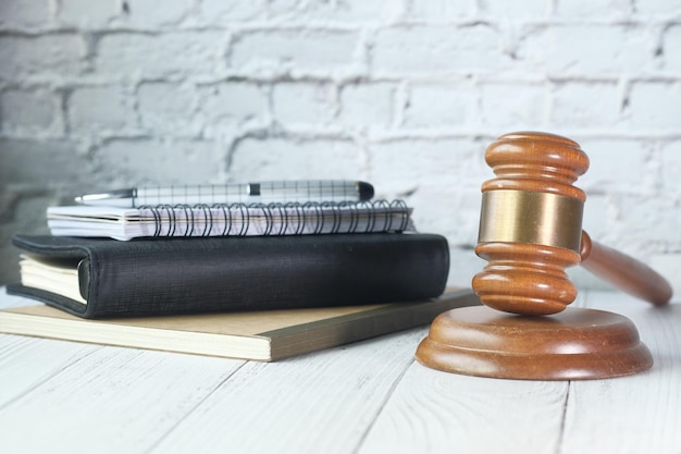 Photo gavel and stack of books on table