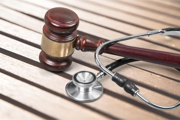 Photo gavel and stethoscope  on background, symbol photo for bungling and medical error