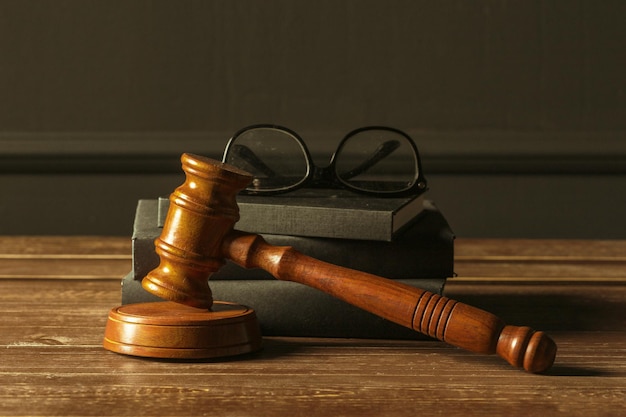 Gavel with books on old wooden desk