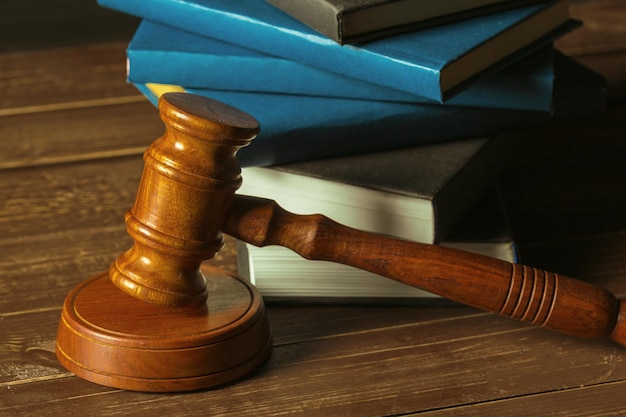 Gavel with books on old wooden desk