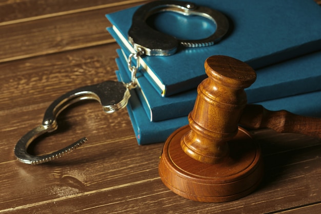 Gavel with books on old wooden desk