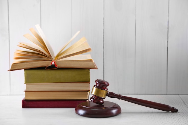 gavel with books on wooden background