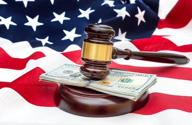 Gavel with money on american flag