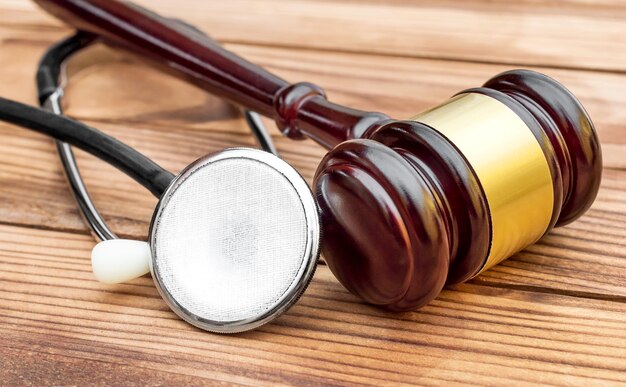 Gavel with stethoscope on wooden table Medical law