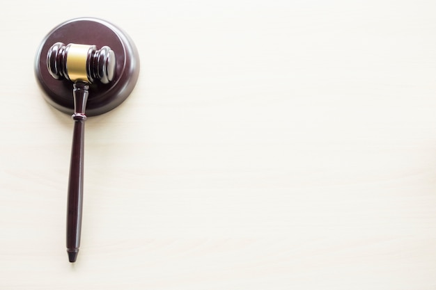 a gavel on a wooden brown desktop, Law, lawyer and justice concept