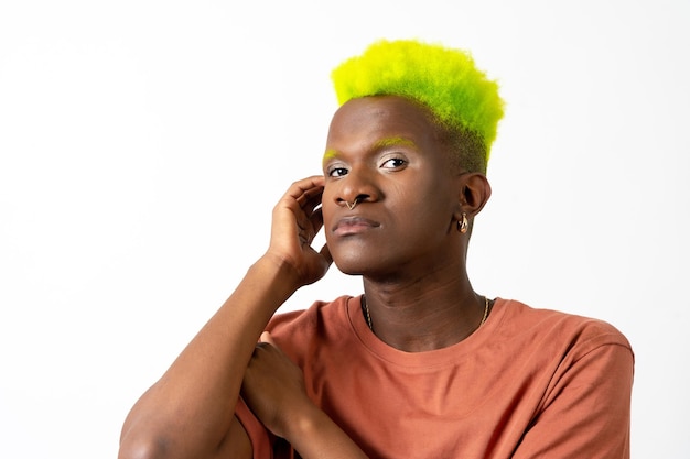 A gay black man in studio with white background LGTBI concept portrait looking at camera