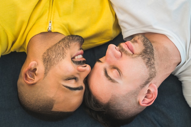 Gay couple laying down on the floor