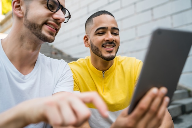 Gay couple using a digital tablet.