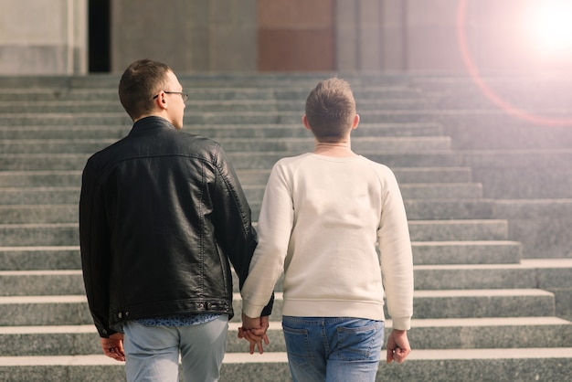 Gay couple walking in city centre, lifestyle