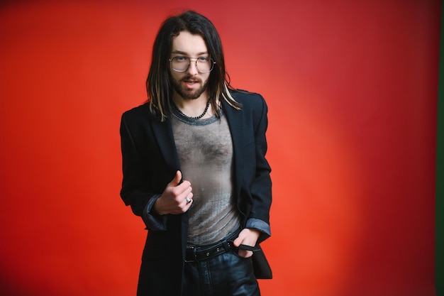 Gay man on a colored background in the studio The concept of the LGBTQ community Equality