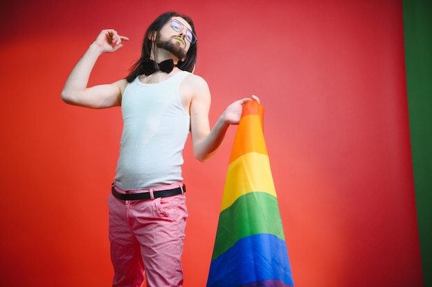 Gay man hold rainbow striped flag isolated on colored background studio portrait people lifestyle fashion lgbtq concept