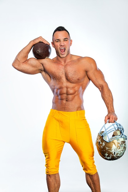 Gay streptizer with naked torso American football player in helmet isolated on white background