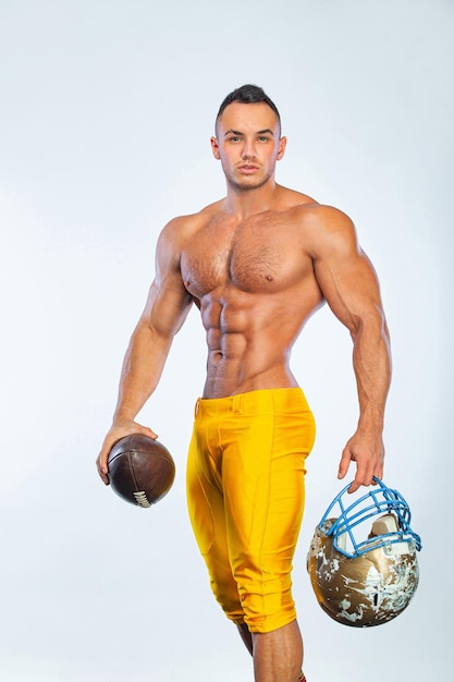 Gay streptizer with naked torso American football player in helmet isolated on white background