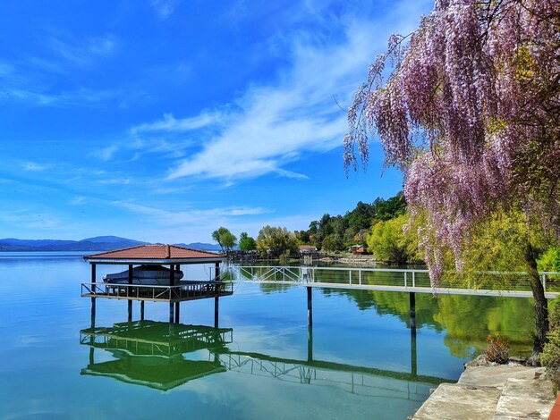 Gazebo by lake against sky