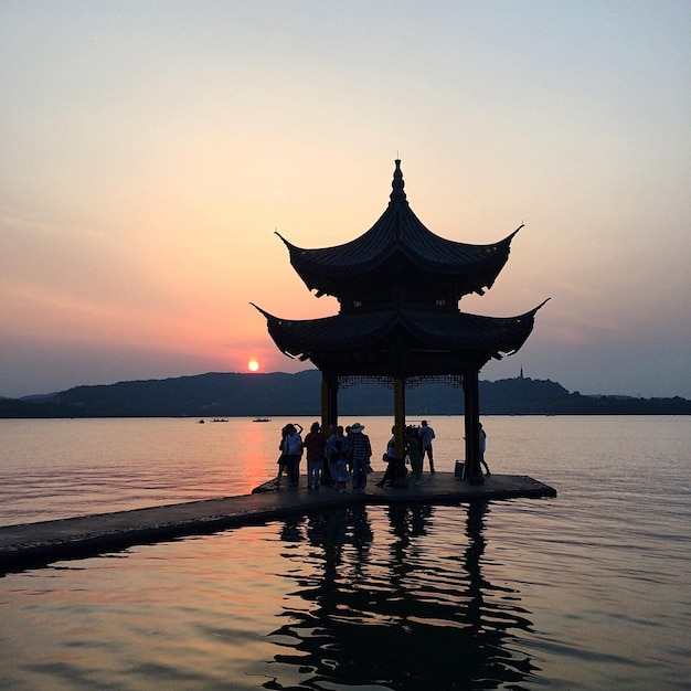 Gazebo on lake at sunset