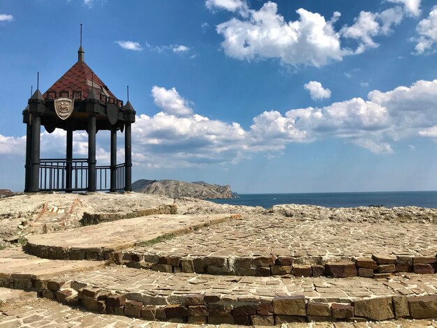 Gazebo in sea against sky