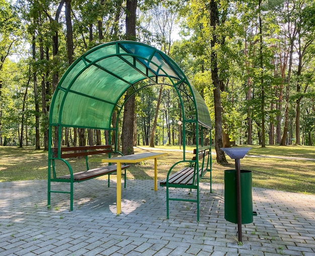 Gazebo with benches and a table in the forest for relaxation