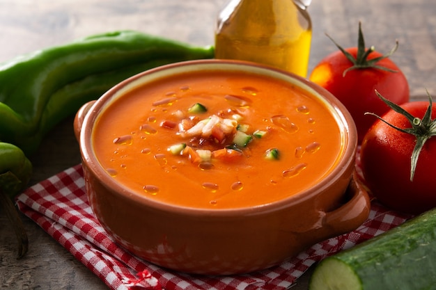 Gazpacho soup in crock pot on wooden table. Typical spanish food