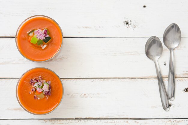 Gazpacho soup in glass on white wooden