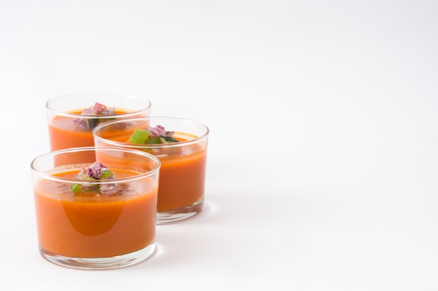 Gazpacho soup in glass on white