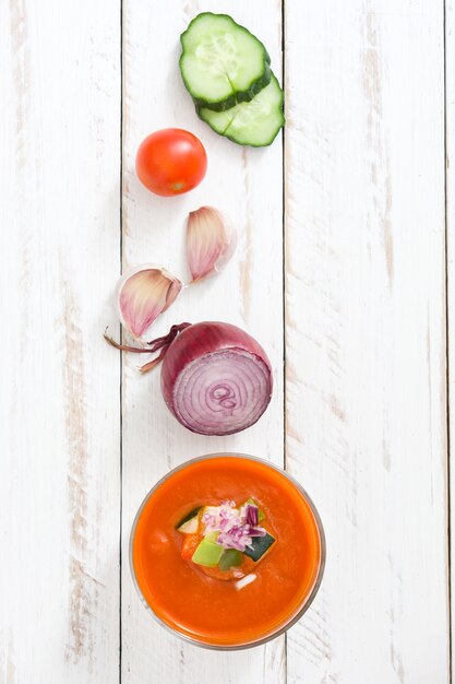 Gazpacho soup in glass on wooden table