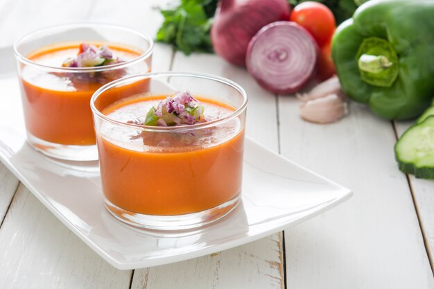 Gazpacho soup on white wooden table